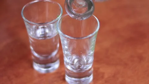 Pouring vodka into glasses Stock Footage 151357355