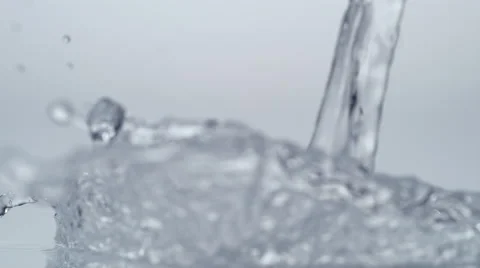 Pouring water and making splashes. Slow Motion. Stock Footage