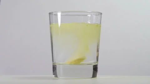 Pouring the water and throwing in a dissolving tablet. Video stock 25873935