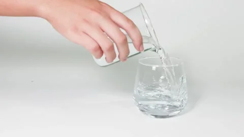 Pouring Water Between Two Glasses Stock Footage 294511719