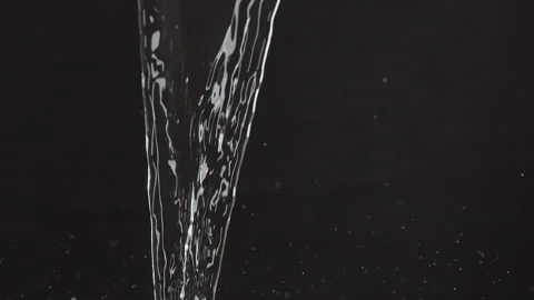 Pouring water on a black background Stock Footage 244733209