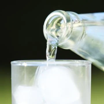 Pouring water close-up Stock Photos