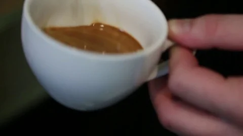 Pouring water into coffee  Stock Footage 75490534