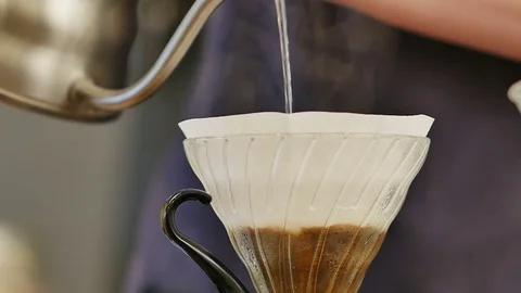 Pouring water on coffee ground with filter Stock Footage