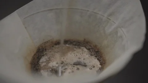 Pouring water onto coffee grounds close up Stock Footage 109500983