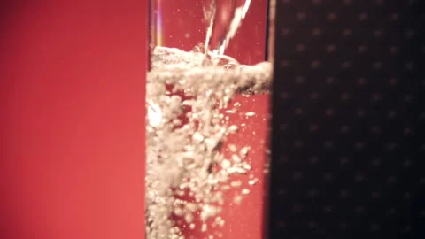 Pouring water in coffee machine red background 60fps Video stock 156044169