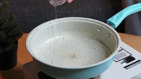 Pouring Water Into Cooking Pan Stock Footage 340300492