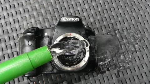 Pouring water on dirty camera sensor funny close up 動画素材 311528400