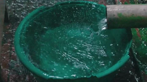 Pouring water in down spout Stock Footage 156006830