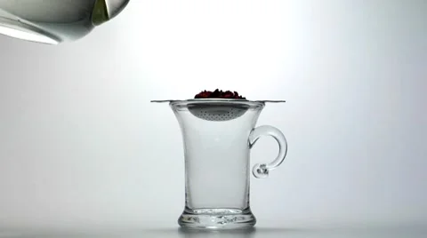 Pouring water onto fruit tea in strainer Stock Footage 8572986