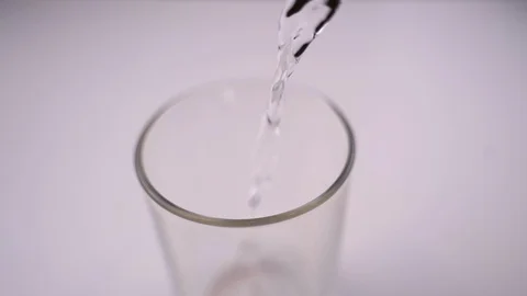 Pouring water into a glass Stock Footage