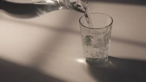 Pouring Water into Glass in SunLight Stock Footage 278938324