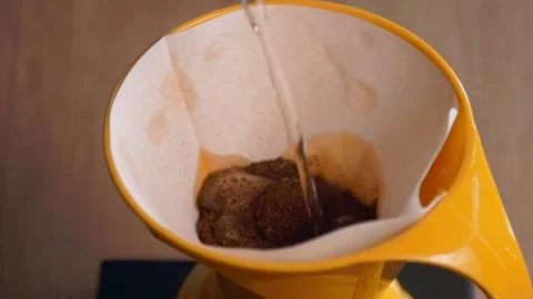 Pouring water on ground coffee - Filter coffee - international coffee day Stockbeeldmateriaal 139941472