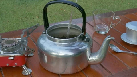 Pouring water into kettle Stock Footage 132310141
