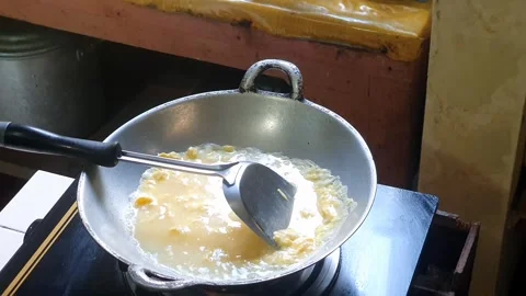 Pouring water into mixed egg or beaten egg or whisked egg in the frying pan.. Stock Footage 279294540