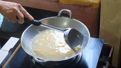 Pouring water into mixed egg or beaten egg or whisked egg in the frying pan.. Stock Footage 279294550