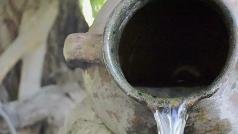 Pouring water from an old jug Stock Footage