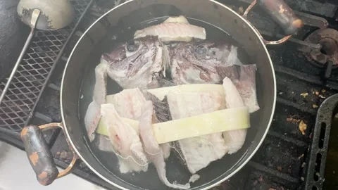 Pouring Water into a Pan of Fish Heads and Bones (Sea Bream), Japanese Food Stock Footage 340930783