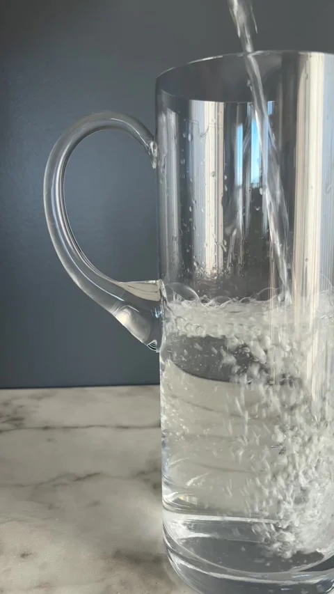 Pouring water into a pitcher Stock-Footage 322938818
