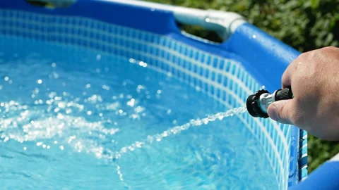 Pouring water into a pool. adding water to the pool Stock Footage 156888009