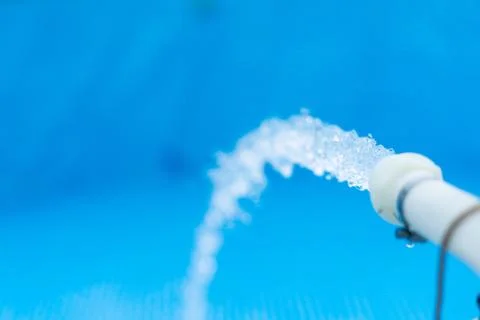 Pouring water into a small pool Stock Photos
