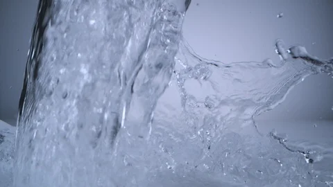 Pouring water on surface. Slow Motion. Stock Footage 128770728