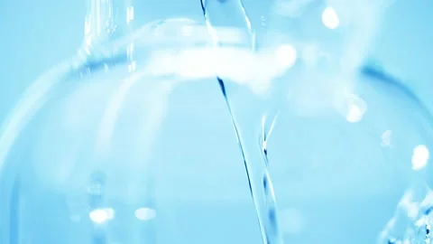 Pouring water into a teapot or pitcher to fill it up. Stock Footage 239773379
