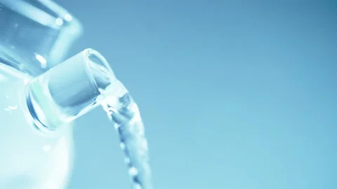 Pouring water into a teapot or pitcher to fill it up. Stock Footage 239773634