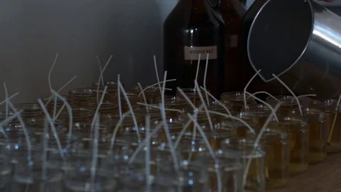 Pouring wax candle making. Stock Footage