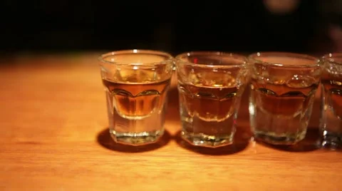 Pouring whiskey shots at a bar Stock Footage