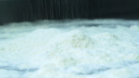 Pouring white flour on a table to cook bread or bakery Stock Footage 100549701