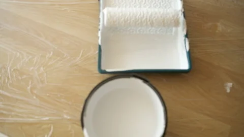 Pouring white paint from a bucket into the bath. Office renovation 스톡 동영상 132792672