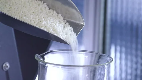 Pouring White Plastic Pellets for Polymer Extrusion Vídeo Stock 338363672