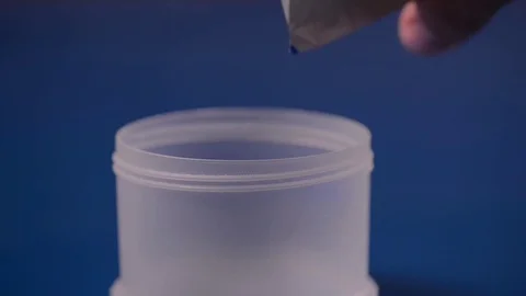 Pouring white powder in a container. Supplement, creatine, hmb, bcaa or vitamin Stock Footage 77727951