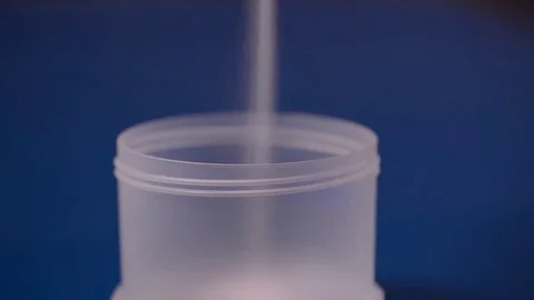 Pouring white powder in a container. Supplement, creatine, hmb, bcaa or vitamin Stock Footage 77727959