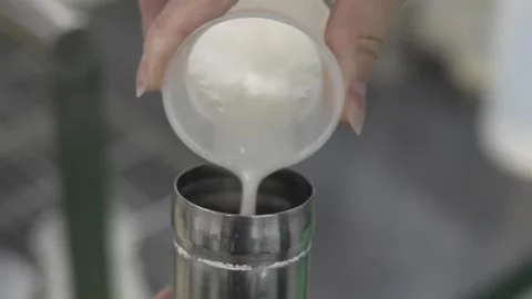 Pouring White Rice Mash Into a Measuring Cylinder Stock Footage 340010468