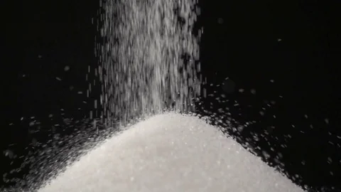 Pouring white sugar on black background Stock Footage 72731019