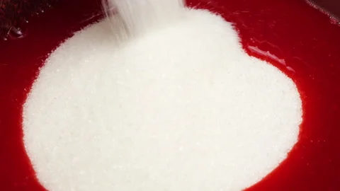 Pouring white sugar into boiling red currant juice.  Stock-Footage 337676435