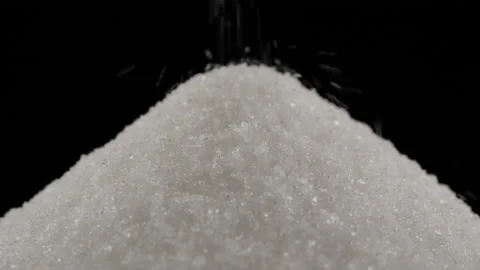 Pouring white sugar, close up on black background Stockbeeldmateriaal 219627930