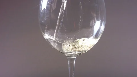 Pouring white wine into a flute Stock Footage 103538324