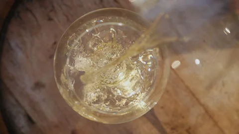 Pouring white wine into a glass Stock Footage 256517838