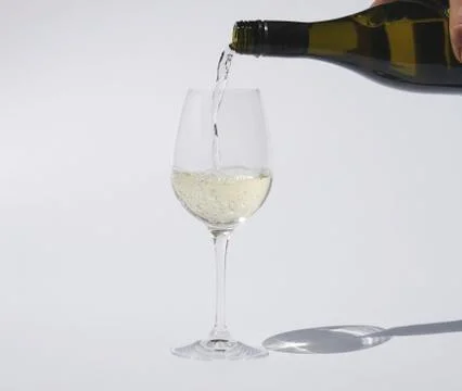 Pouring white wine Stock Photos