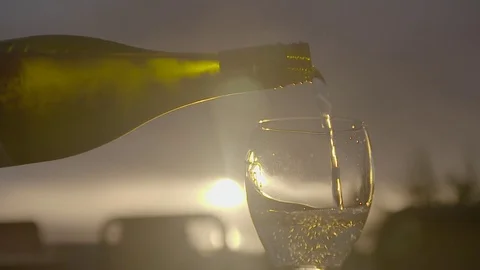 Pouring white wine at sunset 스톡 동영상 74072261