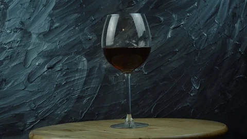 Pouring wine on dark background. Stock Footage 101351129