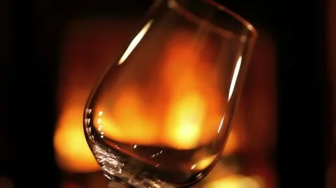 Pouring wine at the fireplace Stock Footage 10863526