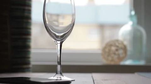 Pouring wine into goblet/glass on table Stock Footage 68909126