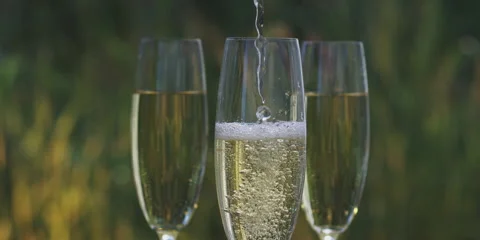 Pouring wine in three glasses Stock-Footage 247382068