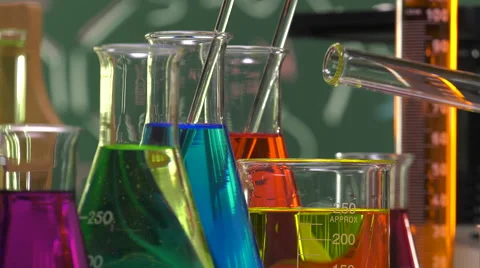 Pouring yellow liquid in a beaker Video stock 64290966