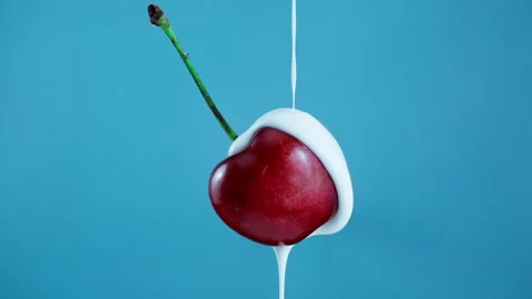 Pouring yoghurt from the top over a cherry in Slow Motion 1000fps Stock Footage 330533977