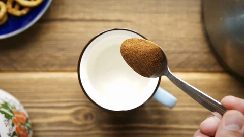 Pours instant coffee into cup Stock Footage 106147539